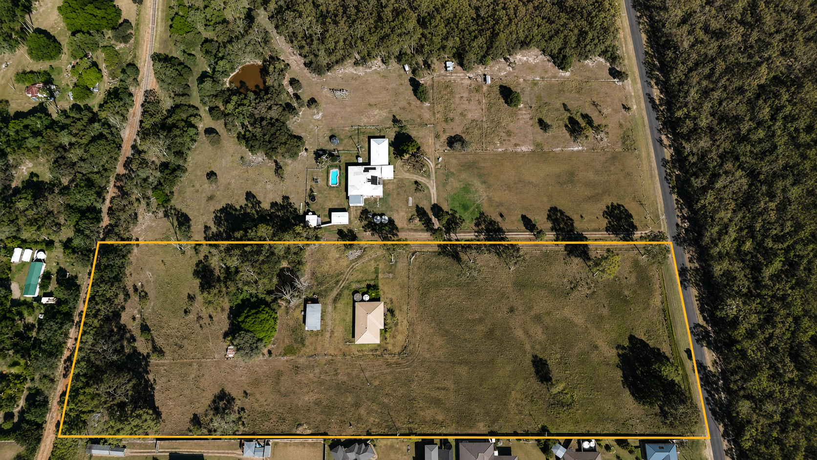 Aerial view of 201 Showgrounds Road, Oakhurst, outlined from above