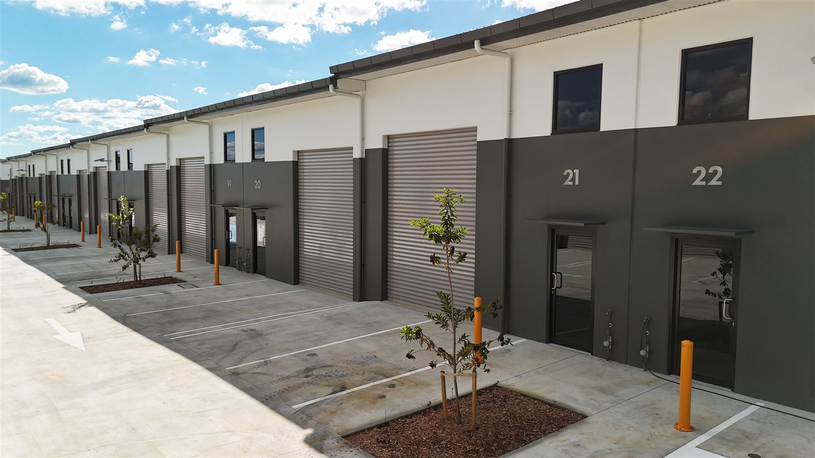 Completed Hillcrest HQ unit frontages with roller doors and landscaping