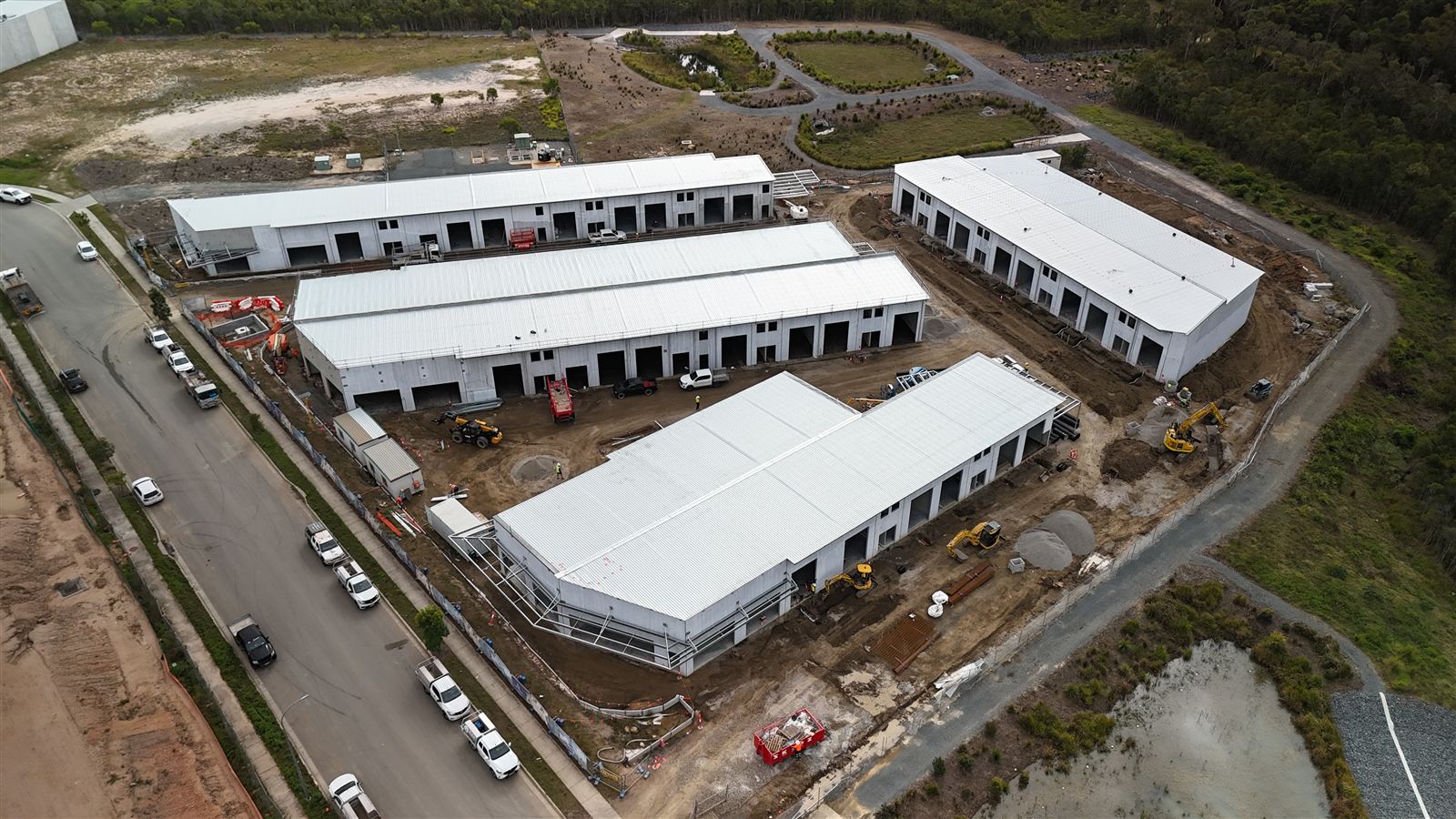 Aerial view of Yarrabilba HQ with roofs on across all four buildings, July 2026