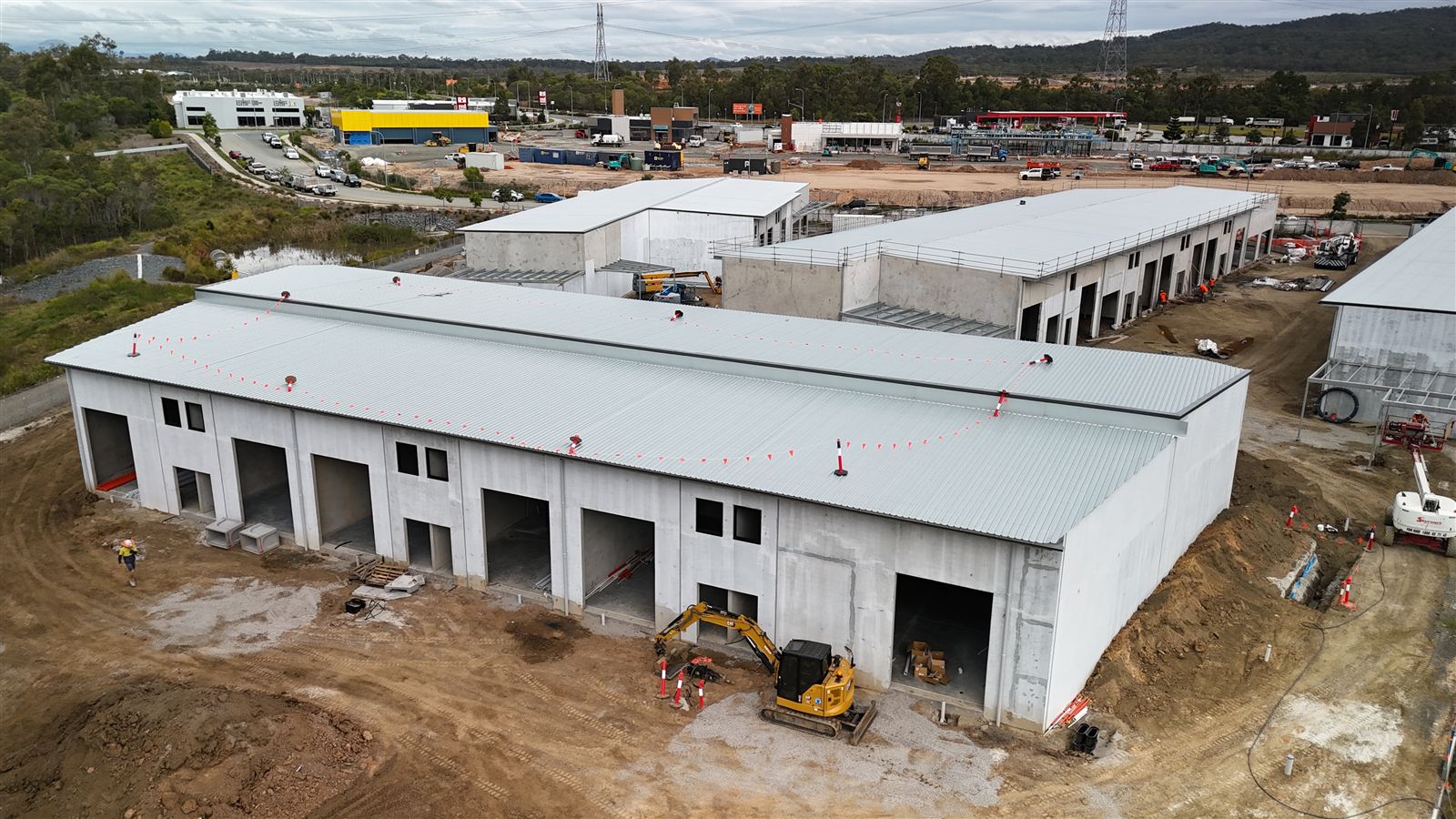 Yarrabilba HQ building with roof complete and roller door openings formed, July 2026